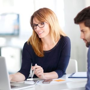 Professional woman discussing tax planning strategies on a laptop, representing USTax101's consulting services for nonresidents and small businesses.